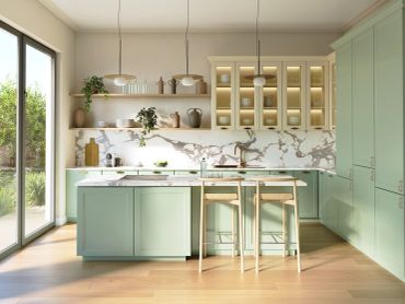 Modern kitchen with green cabinets and natural light.