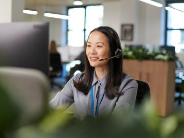 Woman using voice recognition on smartphone.