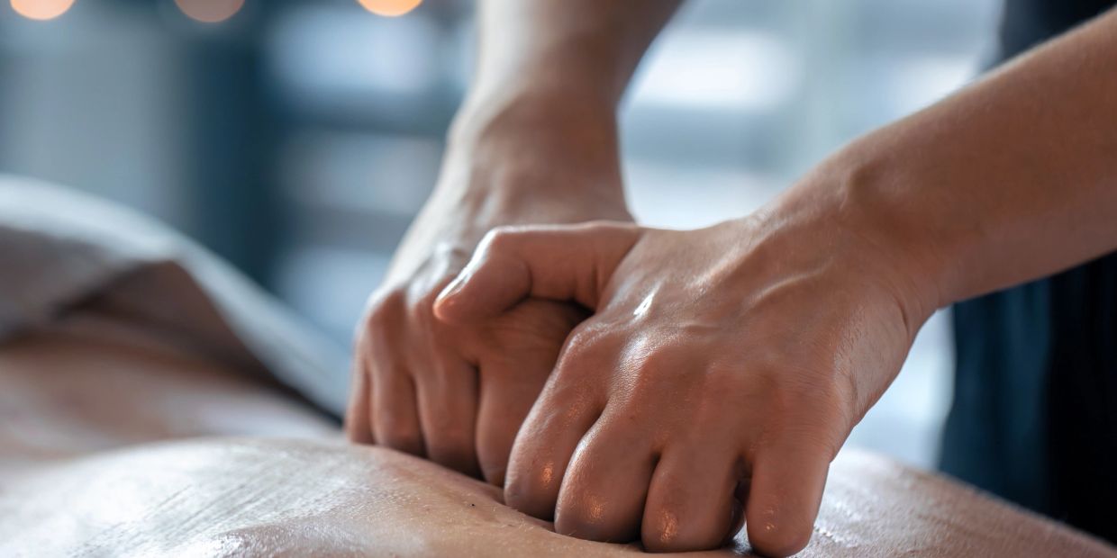 Close-up of hands giving a deep tissue massage.