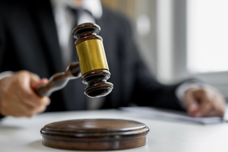 Judge's gavel in hand judges is placed on a table in the legal counsel's office