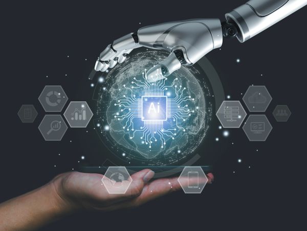 A robotic hand and human hand connecting over a digital AI globe.