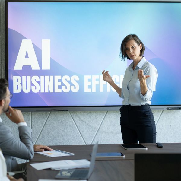 Businesswoman presenting AI business efficiency to colleagues in a modern meeting room.