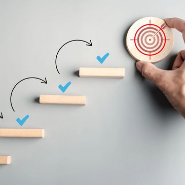 Hand placing target to represent goal achievement.