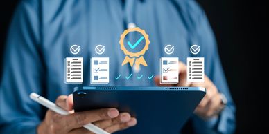 Person holding tablet with digital checklists and a quality badge.