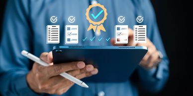 Person holding tablet with digital checklists and quality badge icons.