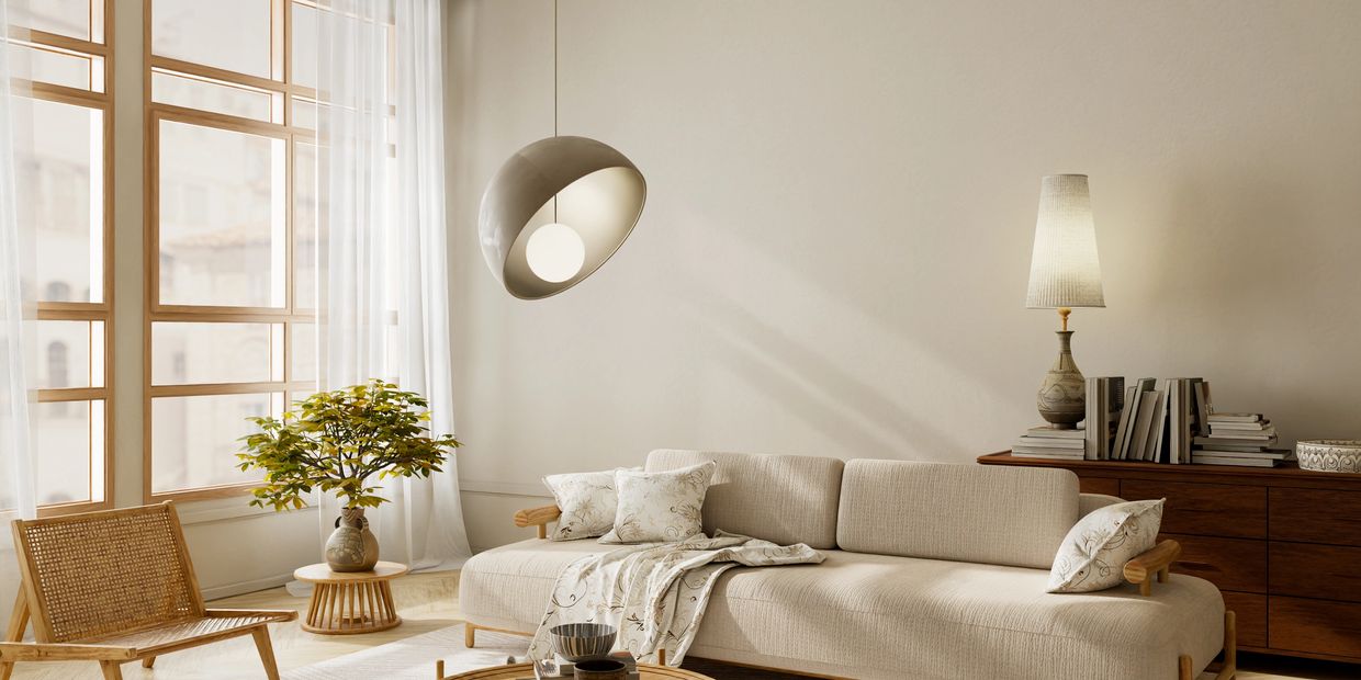 A cozy beige living room with natural light and wooden furniture.