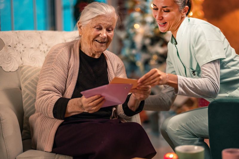 Senior woman handwriting a Christmas or new Year greeting card