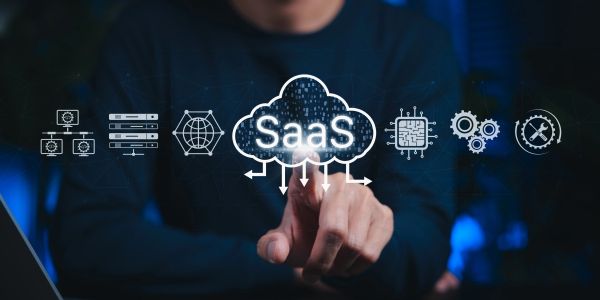 Person pointing at SaaS cloud computing icons.