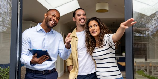 Real estate agent showing a couple a house.
