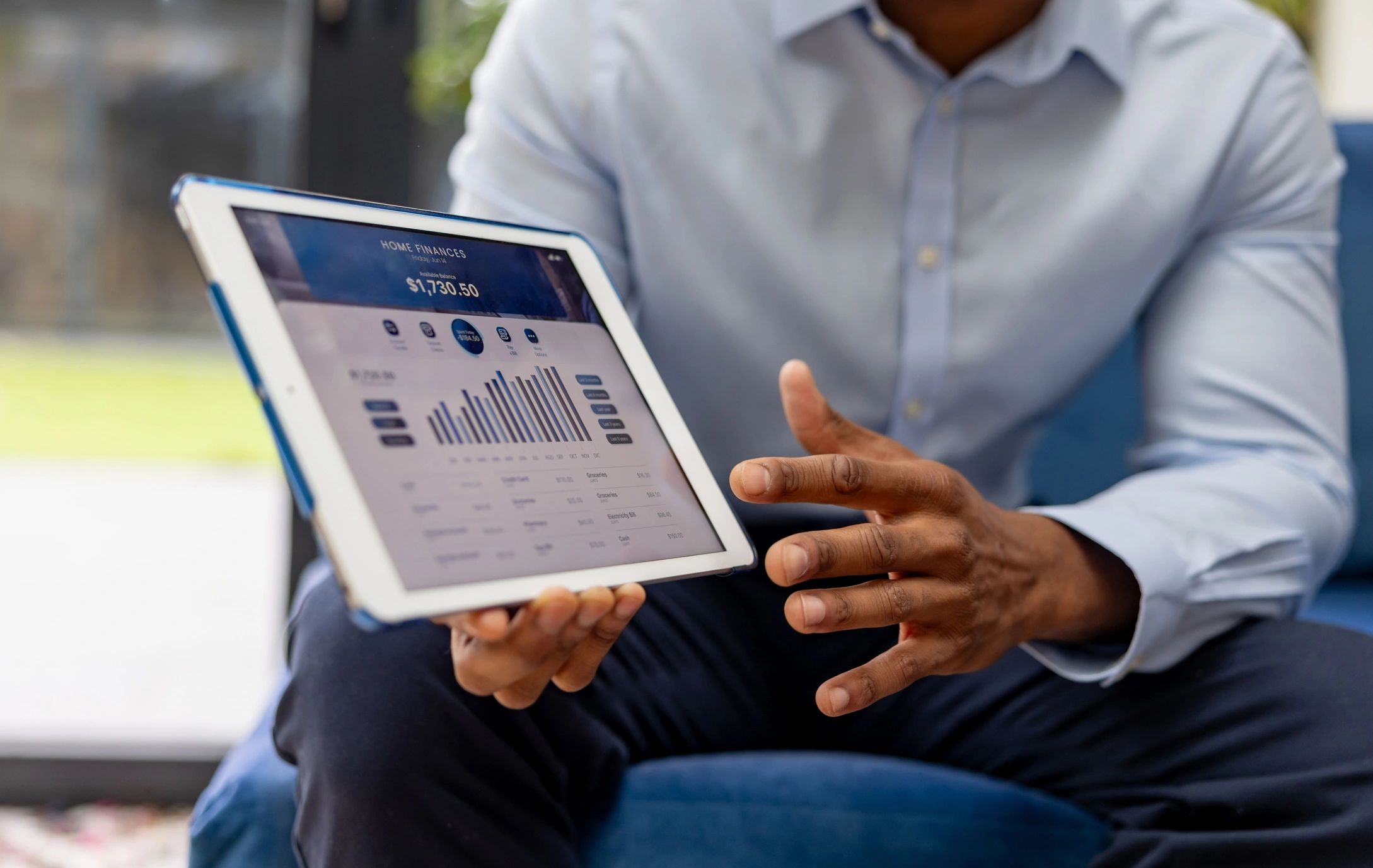 Person showing home finance data on a tablet.