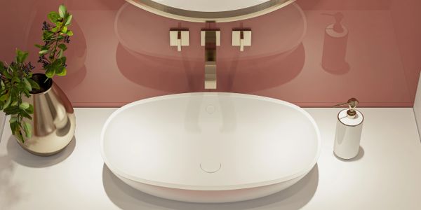 Modern bathroom sink with sleek faucet and decorative plant.