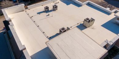 Flat rooftop with HVAC units and clear weather.