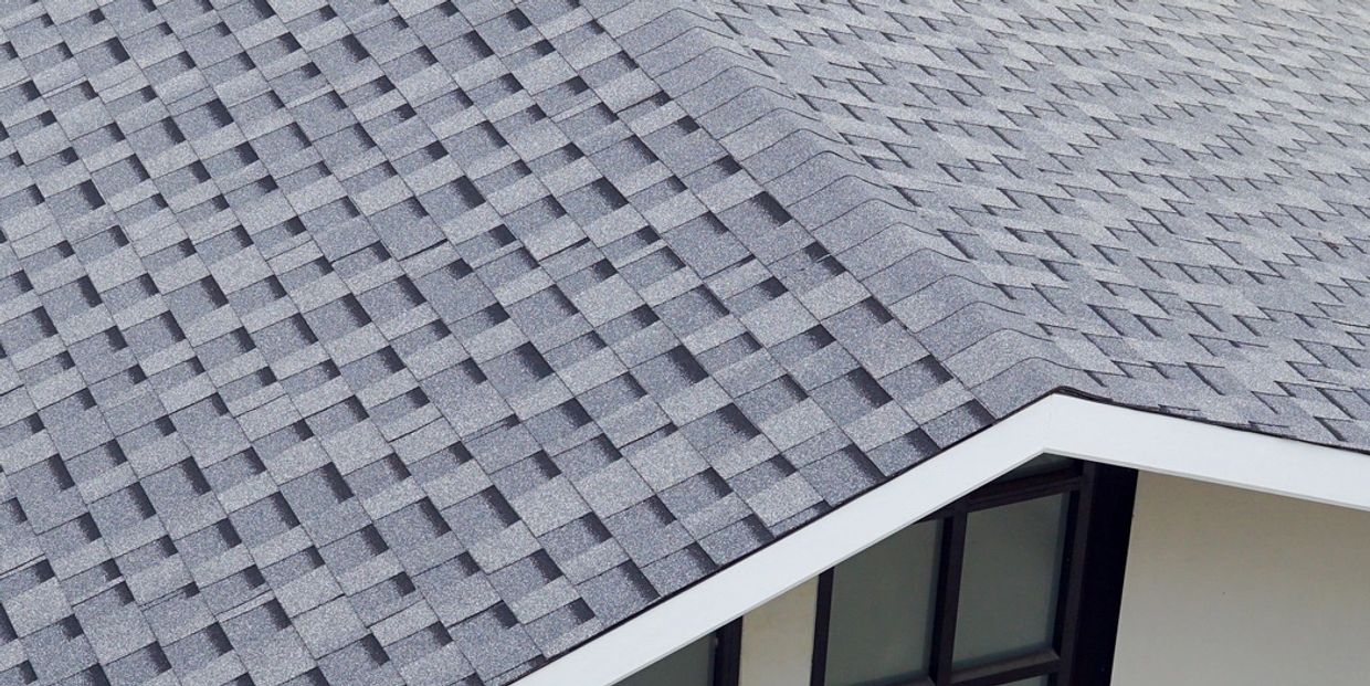 Close-up of a gray shingled roof on a house.
