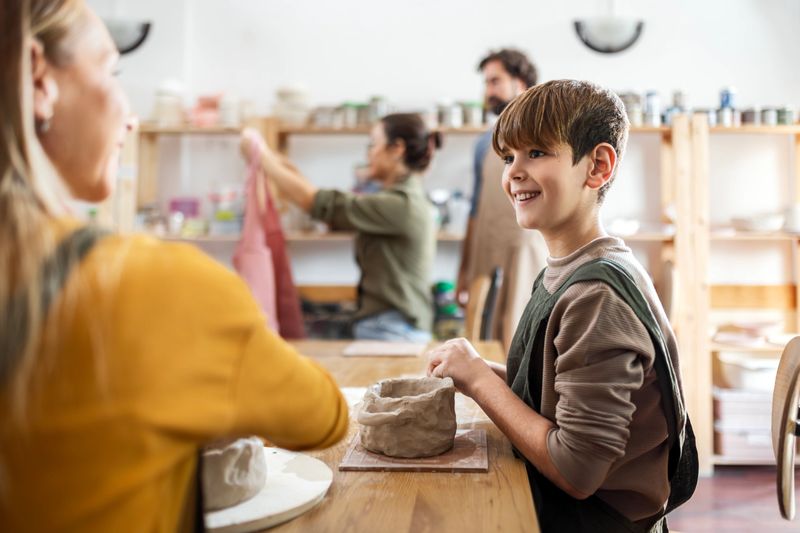Mother And Son With Small Group of People Doing Pottery in an Art Studio