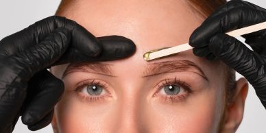 Close-up of eyebrow shaping with waxing.