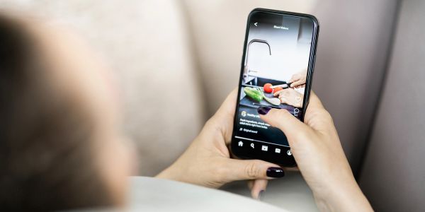 Person watching a cooking video on their smartphone.