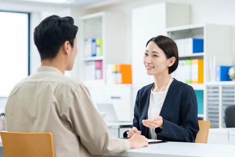 A middle-aged man consulting with a businesswoman
