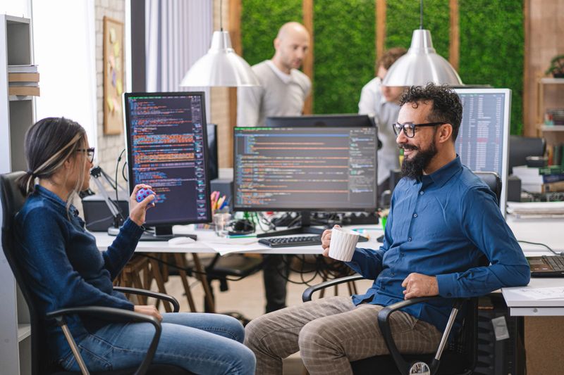 Software programmers analyzing html code and database, brainstorming script ideas to develop new security system. Engineers working with coding language collaborating on group project