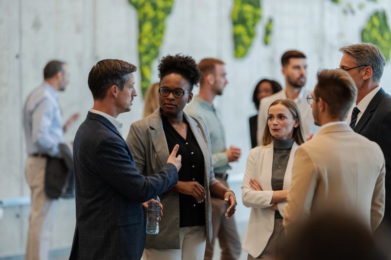 Diverse group of professionals networking at a corporate conference