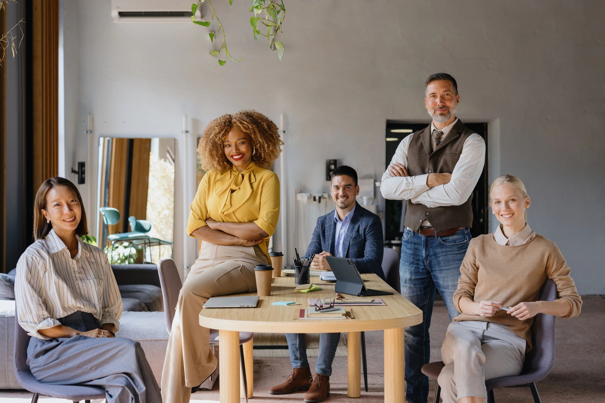Confident diverse team smiling in a modern office setting.