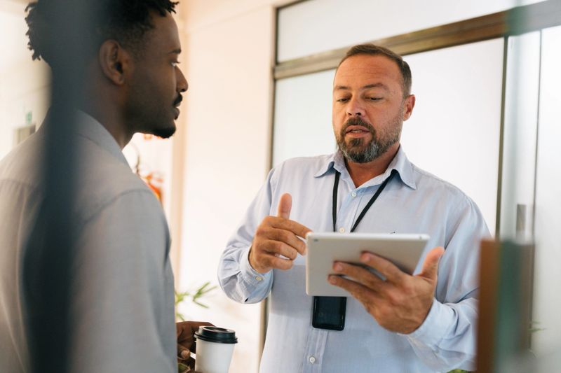 Colleagues reviewing documents together during team meeting