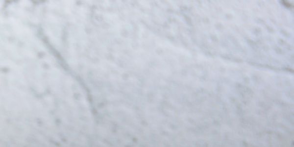 Close-up of textured white and gray concrete surface.