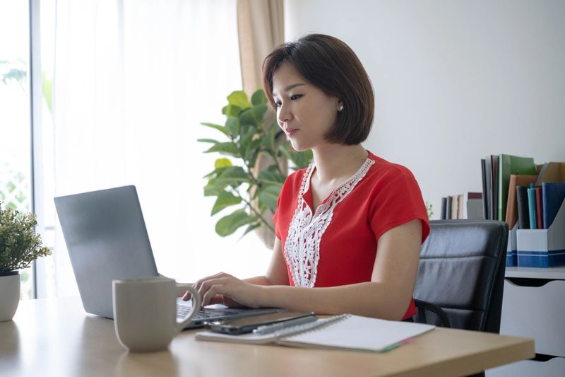 Young businesswoman assesses market data and prepares analytical summaries for strategy discussions.