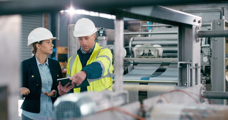 Manufacturing, manager and technician with tablet in factory, productivity or production inspection. Check machinery, automation and people with tech in plant, monitor efficiency and assembly process