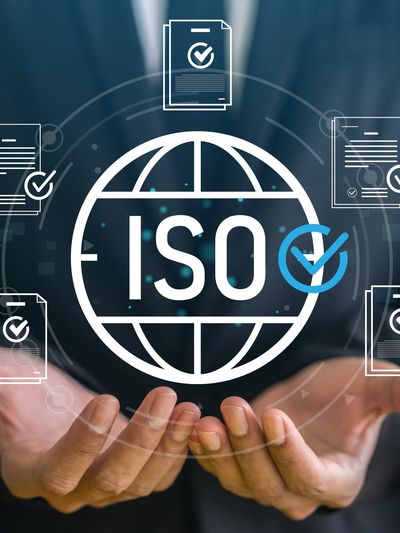 Hands holding a digital ISO certification icon.