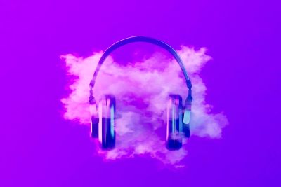 Headphones floating in purple smoke.