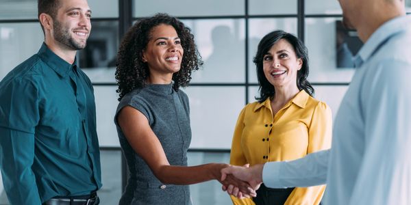 Business greeting with handshake between two colleagues.