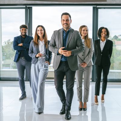 Diverse business team confidently standing in modern office.