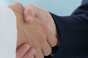 Close-up of a handshake between two people.