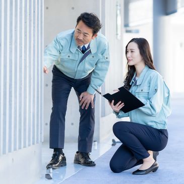 Two appraisers inspecting floor surface.