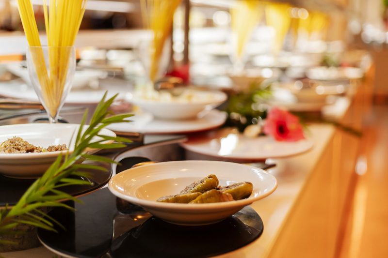 A vibrant buffet showcases a variety of dishes, including appetizers and salads, arranged elegantly in a dining venue.