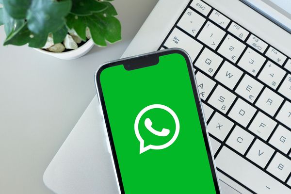 Smartphone showing WhatsApp logo on screen.