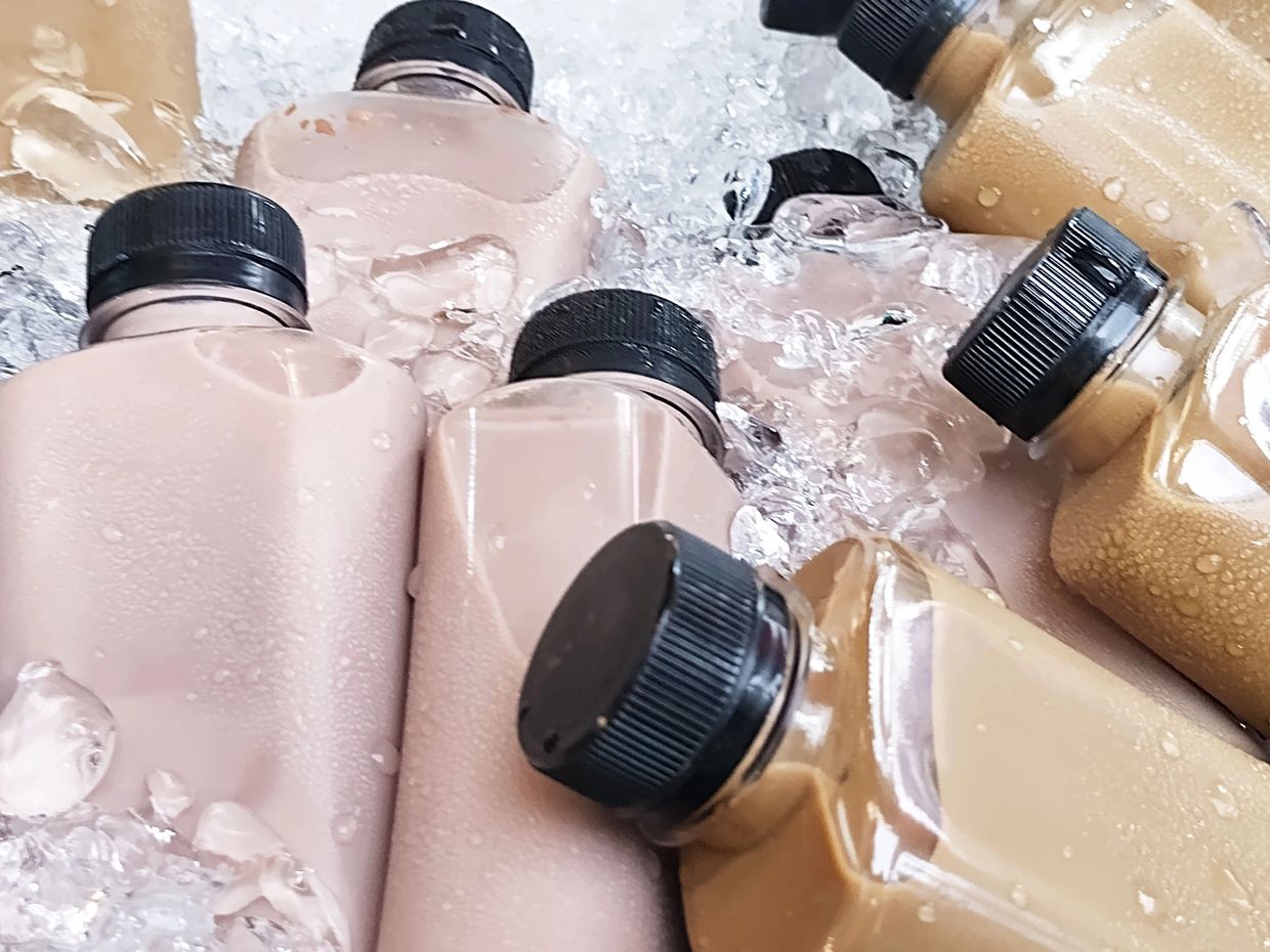 Bottles of iced coffee in a cooler.