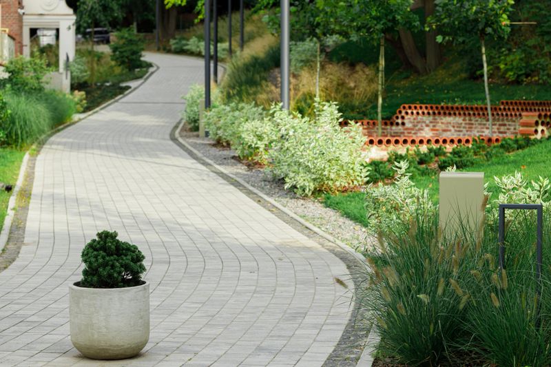landscaped design park pavement foot path track with flower bed and plant pot environment objects in square town idyllic place spring clear weather ordinary day without people here