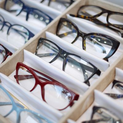 Various eyeglasses displayed in a box.