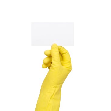 Hand in yellow glove holding a blank white card.