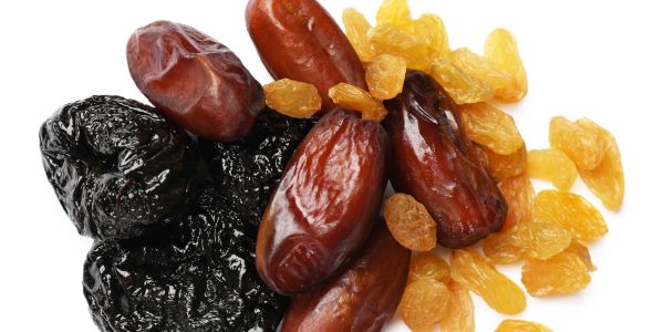 A mix of dried fruits including dates, prunes, and golden raisins.