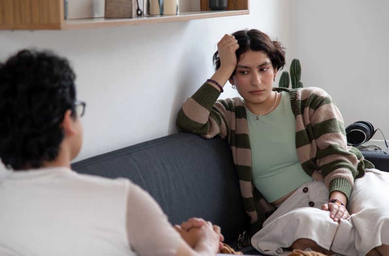 Gen z couple or friends having an argument or discussion in a  living room