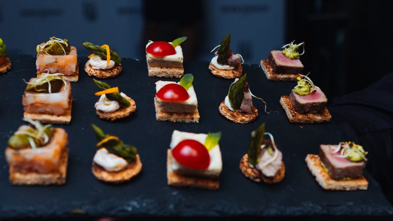 Gourmet appetizers on a slate tray. Concept for luxury catering, fine dining, and sophisticated celebrations.