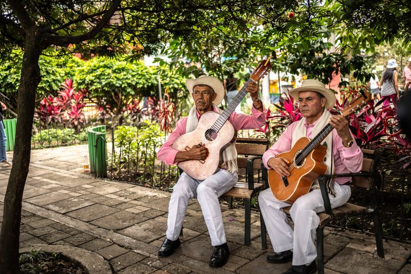 Traditional musicians playing acoustic guitar on Medellin, in Colombian