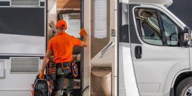 Worker entering a camper van door.