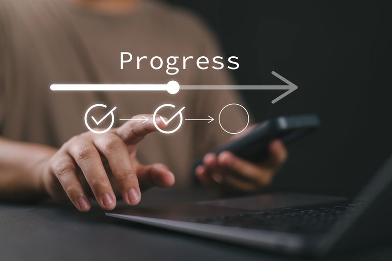 A man touching to tick correct mark in checklist with progressive loading status to remind work task progressive for project development management and tracking concept.