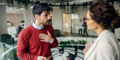 Two colleagues having a serious conversation at work.