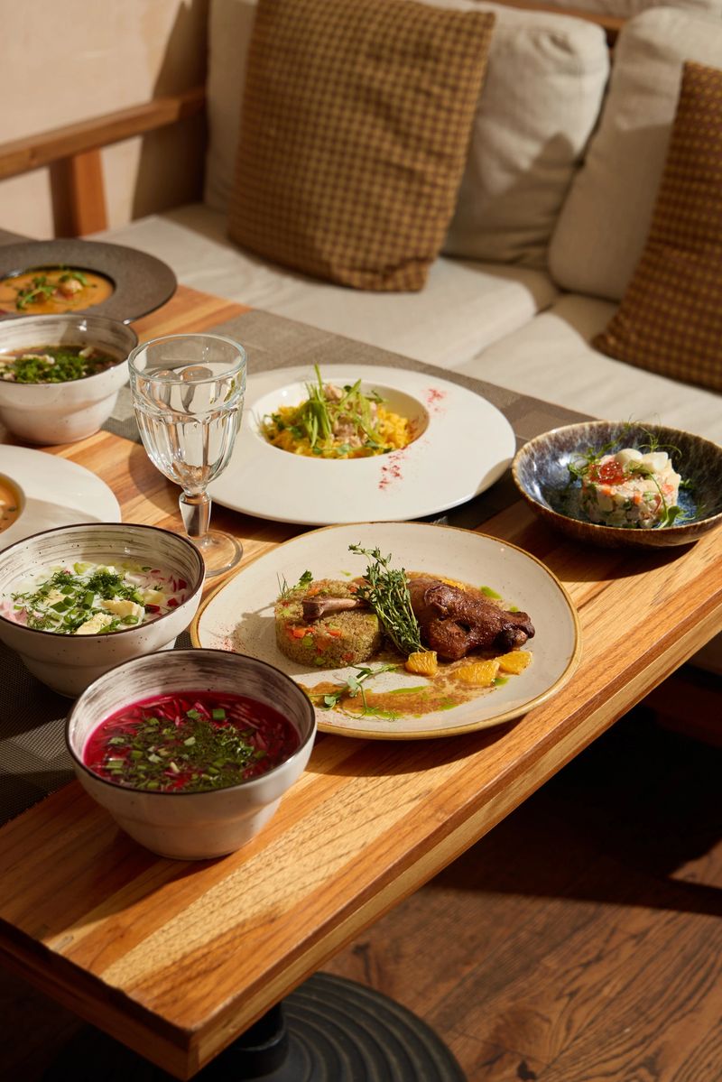 A beautifully arranged table featuring diverse dishes and a cozy seating area for an enjoyable dining experience.