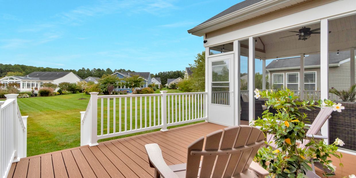 Custom wood and composite deck by Beautiful Homes LLC with white railings and durable outdoor design
