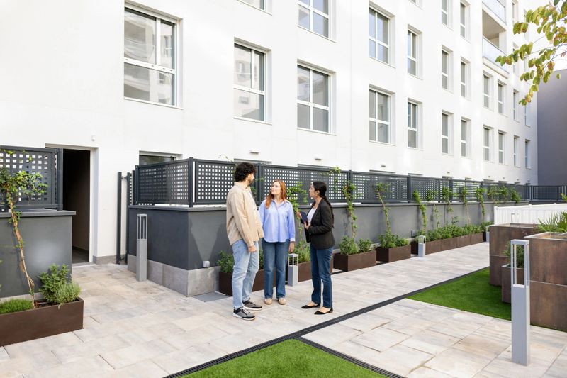 Couple discussing new apartment with real estate agent